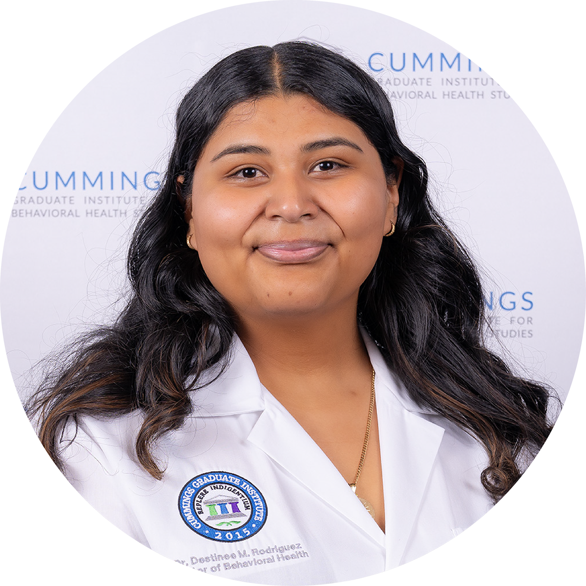 Dr. Destinee Rodriguez, DBH, wearing a CGI white coat at the DBH commencement ceremony.