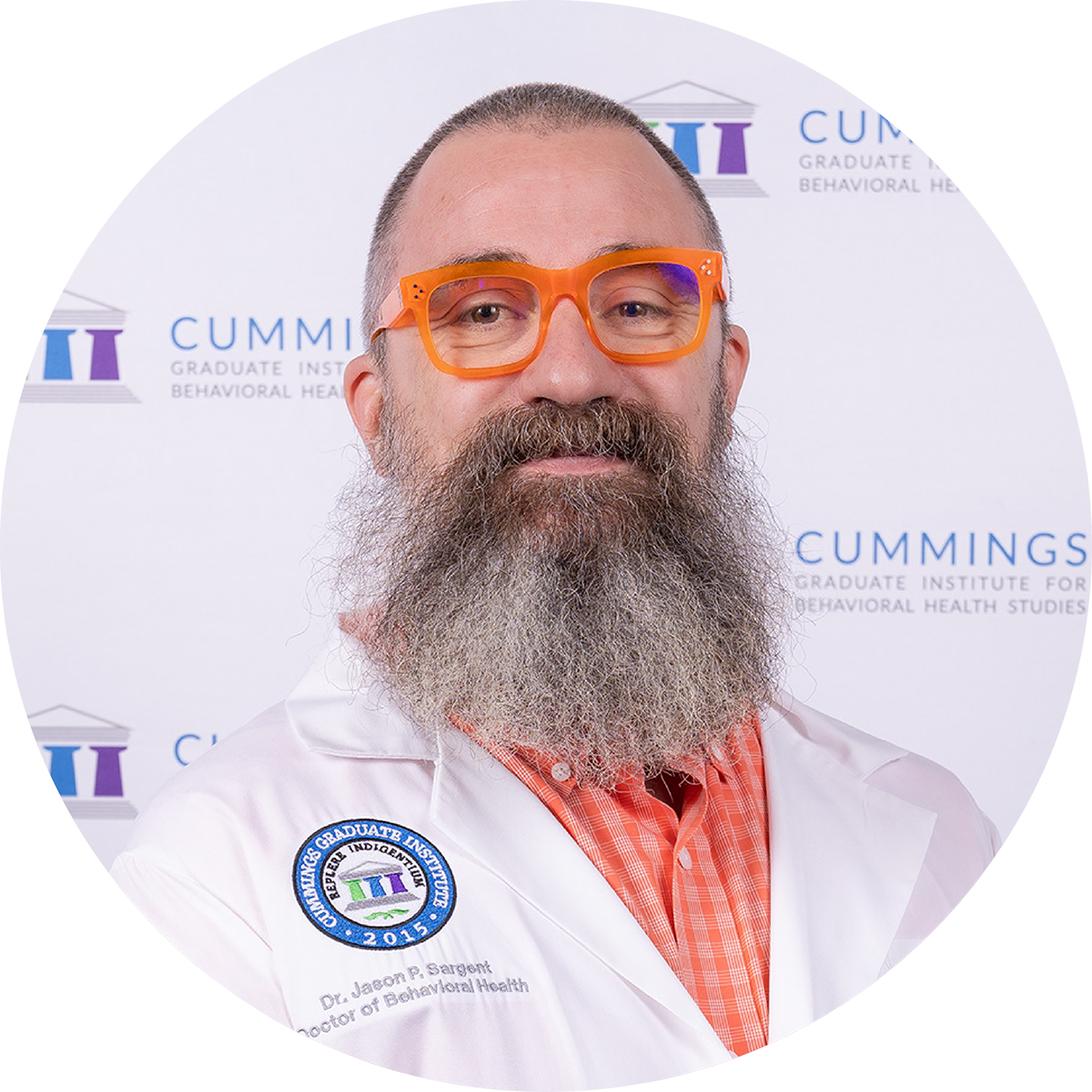 Dr. Jason Sargent, DBH, wearing a CGI white coat at the DBH commencement ceremony.
