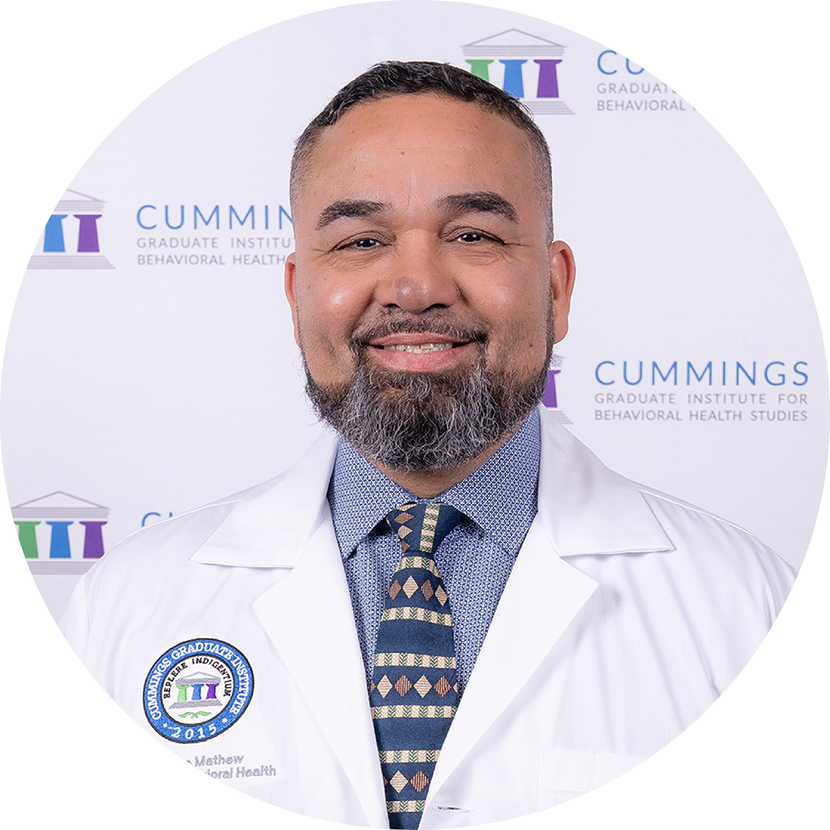 Dr. Jose Mathew, DBH, wearing a CGI white coat at the DBH commencement ceremony.