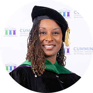DBH graduate Dr. Nikole Jiggetts smiling in academic regalia and doctoral tam.
