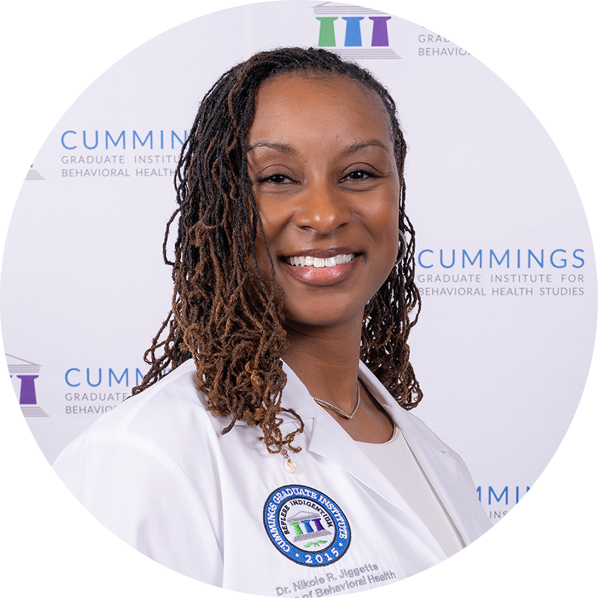 Dr. Nikole Jiggetts, DBH, wearing a CGI white coat at the DBH commencement ceremony.