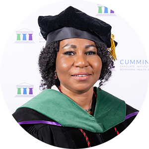 DBH graduate Dr. Roseline Obealor smiling in academic regalia and doctoral tam.