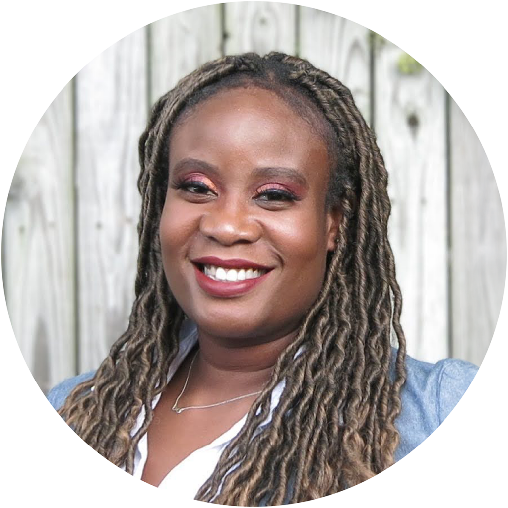 Photo of Ngozika Egbuonu, DBH student and author of this article, smiling and standing in front of a wood background